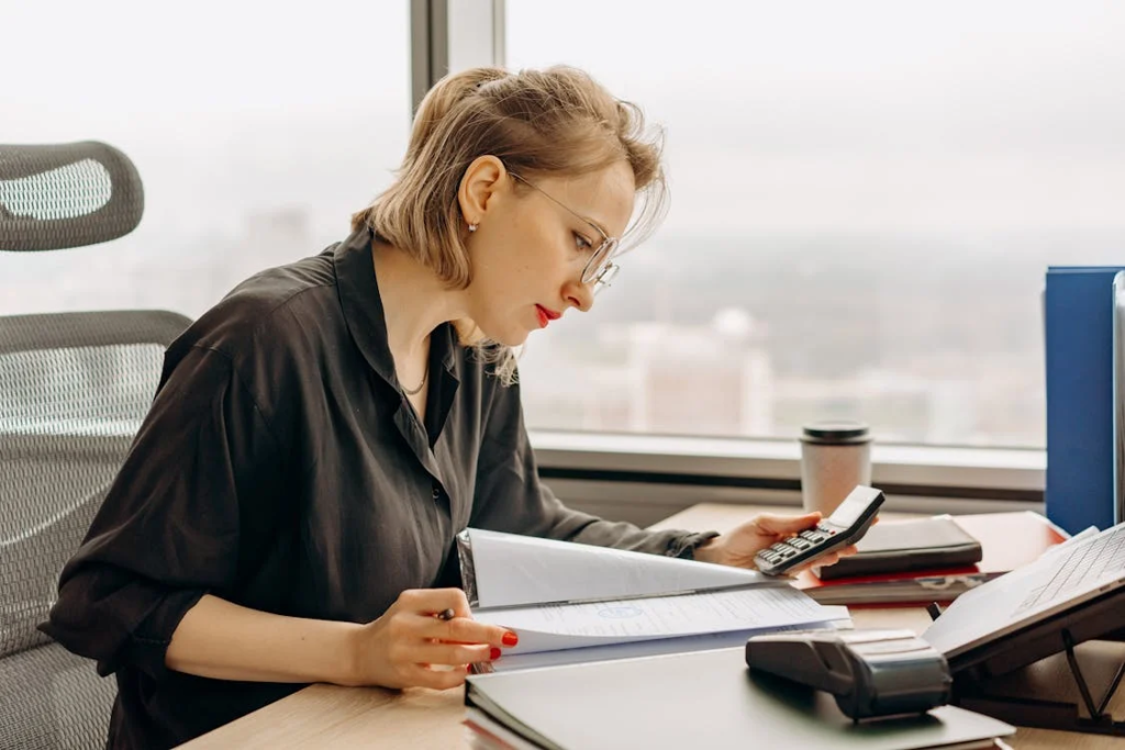 woman calculating documents